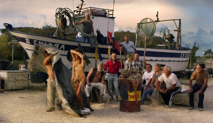 naked girl caught in net surrounded by fishermen