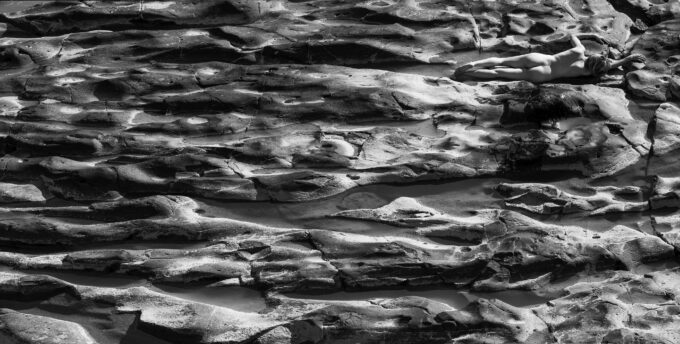 Naked woman on rocks